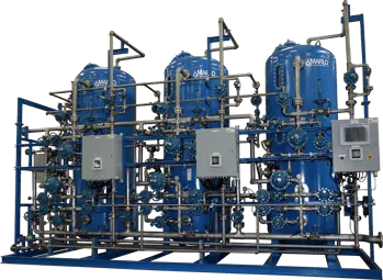 Blue industrial filtration system with multiple tanks, pipes, and control panel.